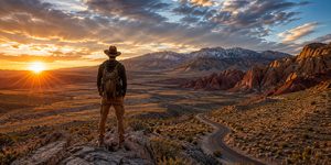 Hiker overlooking the Nevada desert and mountains at sunset.