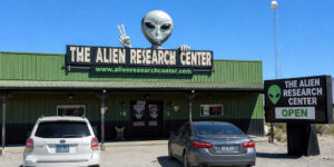 The Alien Research Center roadside attraction in Hiko, Nevada, featuring a large alien figure and roadside signs.